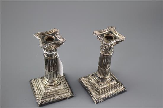 A pair of Edwardian silver corinthian column dwarf candlesticks by Williams Ltd, Birmingham, 1905, height 16.4cm, weighted, a.f.